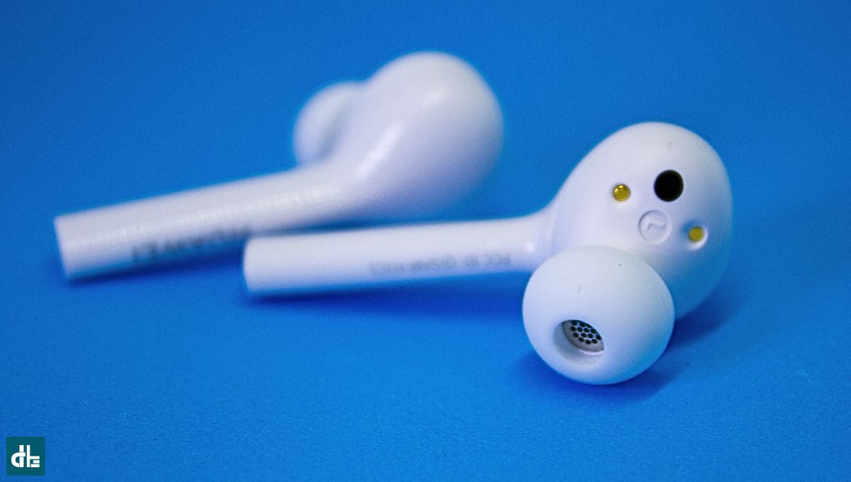 Bluetooth earbuds put on a table to improve sound quality of earbuds